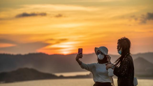 Tourists enjoy the view of the sunset in Indonesia. Photo credit: Asian Development Bank.