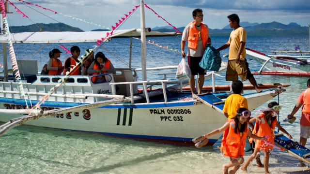 Tourists getting off a boat in Boracay, Philippines. 
