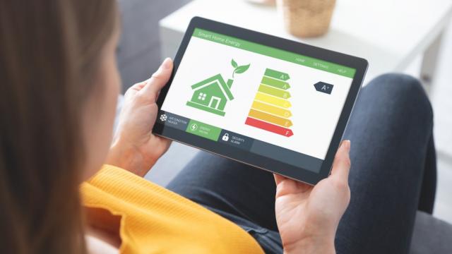 Energy efficiency mobile app on screen, eco house stock photo. Photo credit: iStock/simpson83.